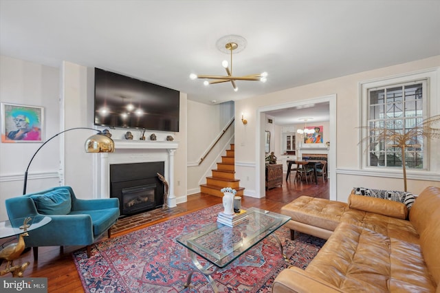 living room with hardwood / wood-style floors and an inviting chandelier