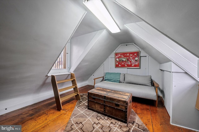 living area with hardwood / wood-style floors and vaulted ceiling