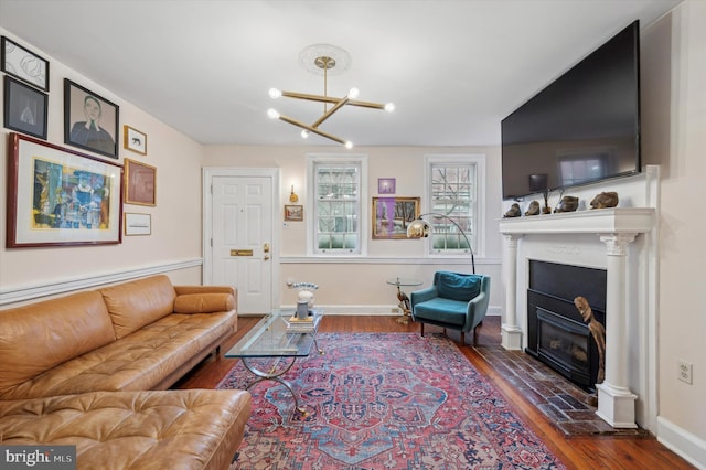 living room featuring dark wood-type flooring and a chandelier