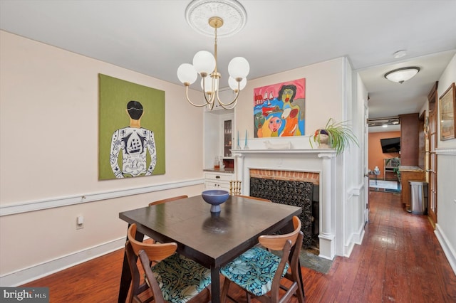 dining space with an inviting chandelier and dark hardwood / wood-style flooring