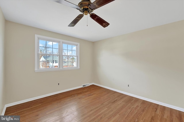 empty room with hardwood / wood-style flooring and ceiling fan