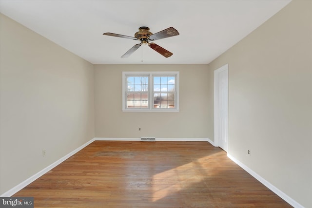 spare room with ceiling fan and light wood-type flooring