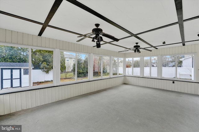 unfurnished sunroom featuring a healthy amount of sunlight and ceiling fan