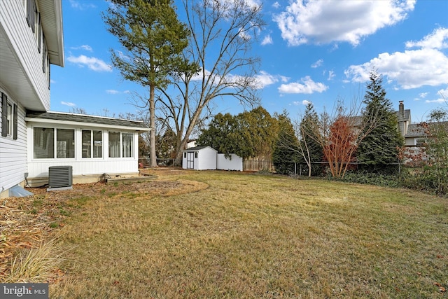 view of yard with cooling unit, a storage shed, and a sunroom