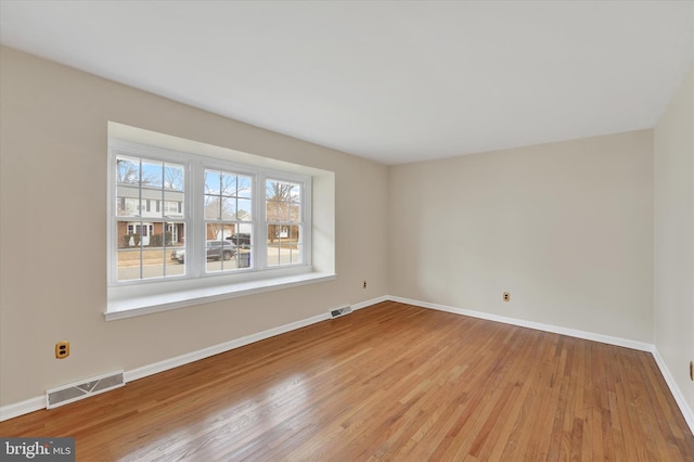 spare room with light wood-type flooring