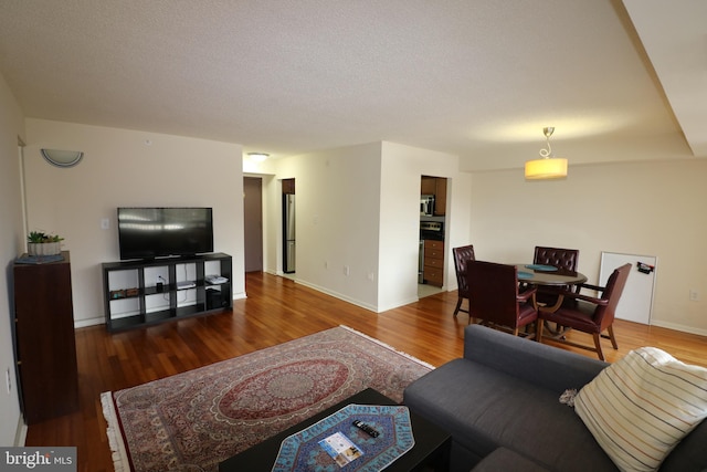 living room featuring hardwood / wood-style floors and a textured ceiling