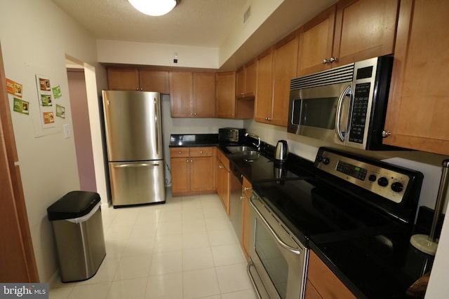 kitchen with sink and appliances with stainless steel finishes