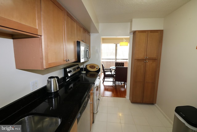 kitchen with stainless steel appliances and a textured ceiling