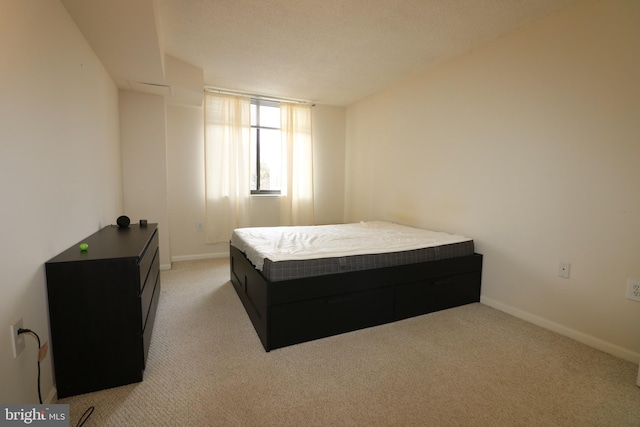 carpeted bedroom with a textured ceiling