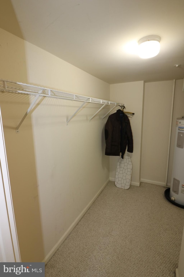 spacious closet with carpet and electric water heater