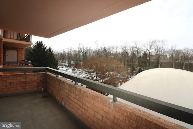 view of snow covered back of property