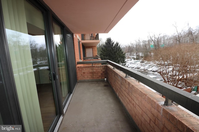 view of snow covered back of property