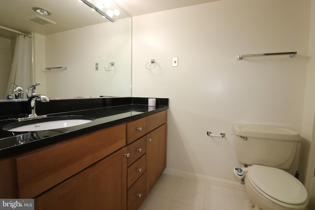 bathroom with vanity, toilet, and tile patterned flooring