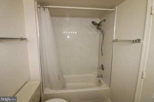 bathroom with shower / bath combination with curtain and toilet