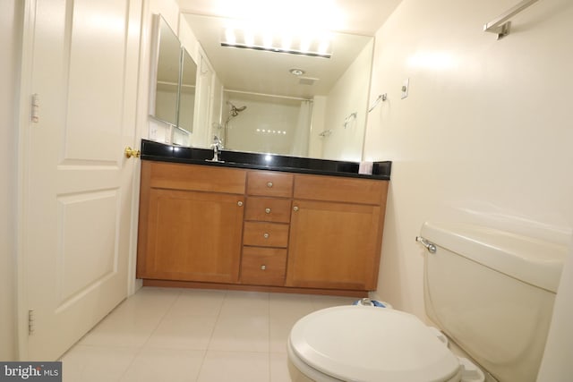 bathroom with vanity, tile patterned floors, a shower, and toilet