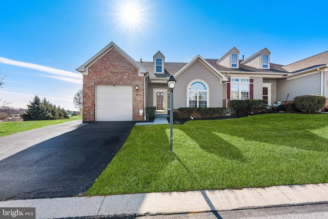 view of front of home featuring aphalt driveway, a garage, brick siding, and a front lawn