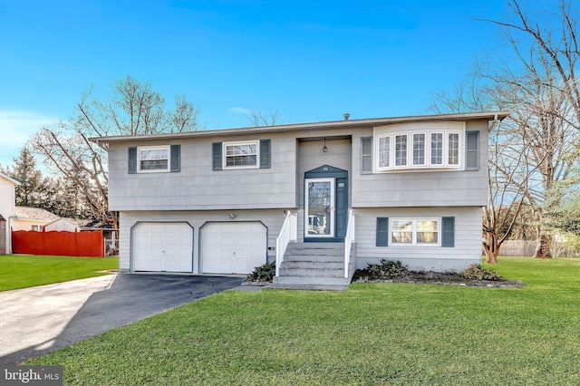 bi-level home featuring a garage and a front yard