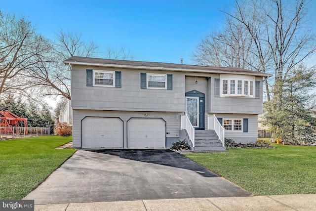 bi-level home featuring a garage and a front yard