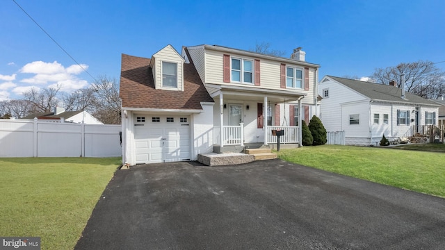 view of front of house with a garage and a front lawn