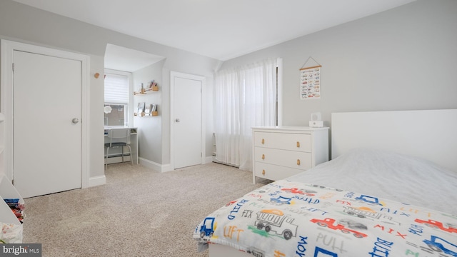 carpeted bedroom with baseboard heating