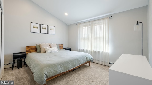 bedroom with vaulted ceiling, carpet, and baseboard heating