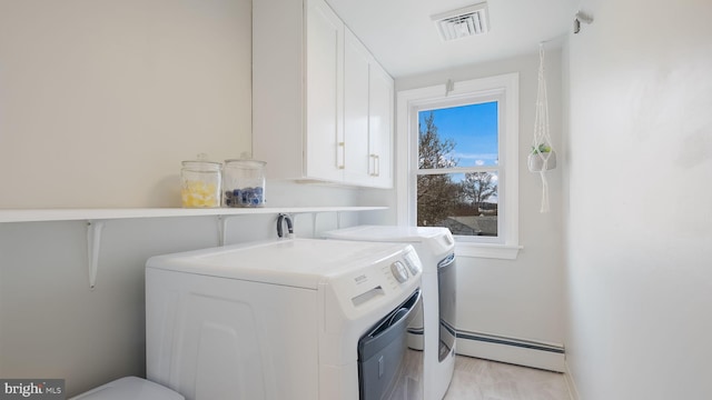 clothes washing area with a baseboard heating unit and independent washer and dryer