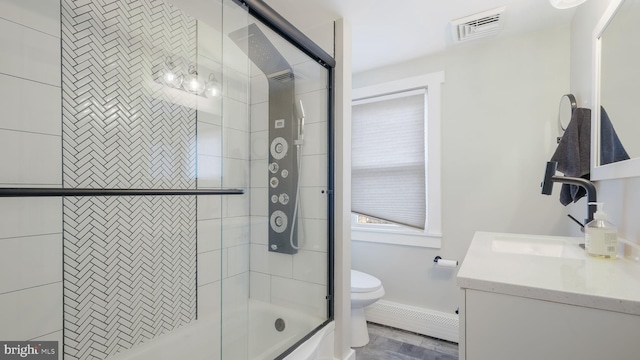 full bathroom with enclosed tub / shower combo, vanity, and toilet