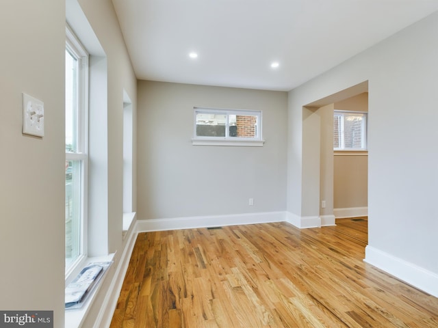 empty room featuring plenty of natural light and light wood-type flooring