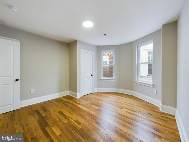 unfurnished room featuring hardwood / wood-style floors