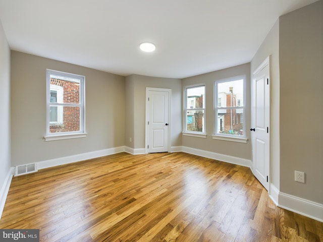 unfurnished room with light hardwood / wood-style flooring