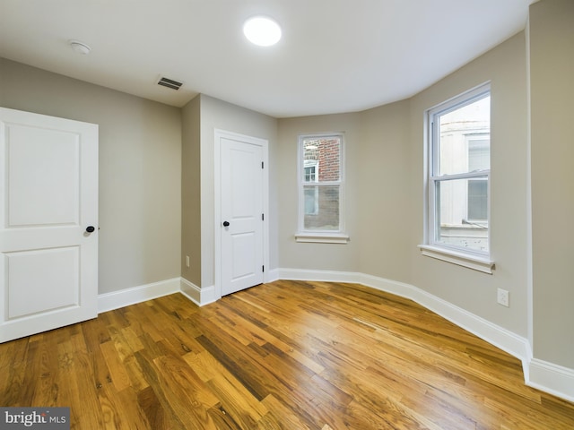 empty room with wood-type flooring