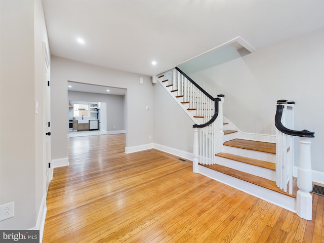 staircase with wood-type flooring