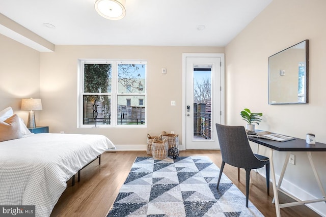 bedroom featuring access to exterior and light hardwood / wood-style flooring