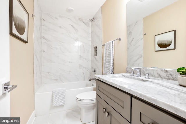 full bathroom featuring tiled shower / bath, vanity, and toilet