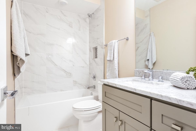 full bathroom with vanity, toilet, and tiled shower / bath