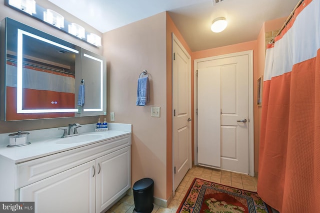 bathroom with vanity, curtained shower, and tile patterned floors