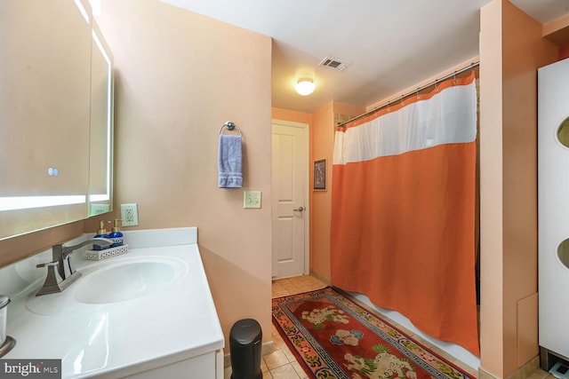 bathroom featuring a shower with shower curtain, tile patterned flooring, and vanity