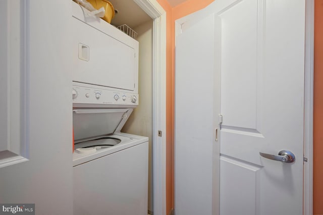 laundry room with stacked washer / dryer