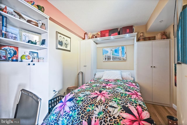 bedroom featuring a textured ceiling and hardwood / wood-style floors