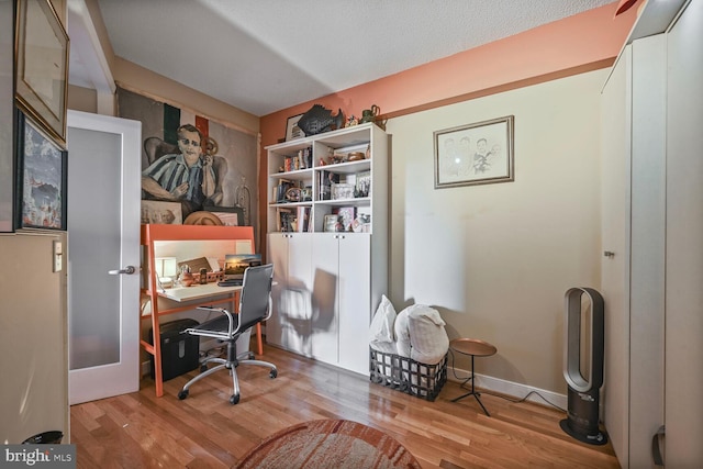 office featuring light wood-type flooring and french doors