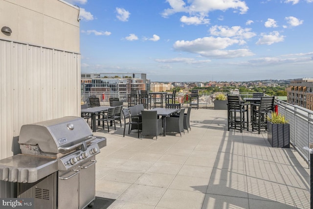 view of patio / terrace featuring an outdoor bar, area for grilling, and a grill