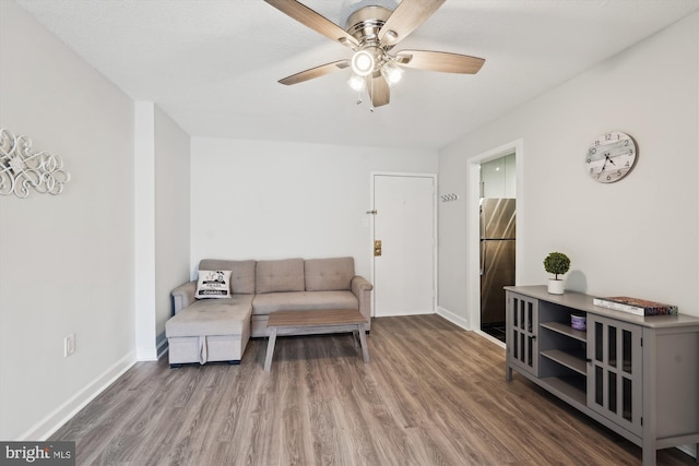 living room with wood-type flooring and ceiling fan