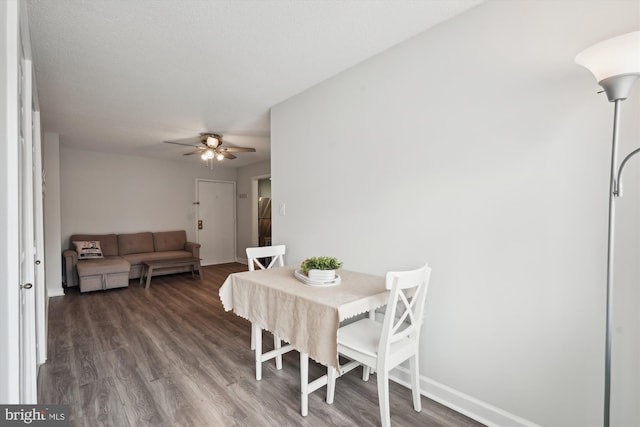 dining room featuring ceiling fan and dark hardwood / wood-style flooring