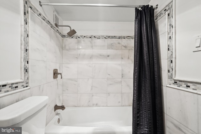 bathroom with tile walls, shower / bath combination with curtain, and toilet