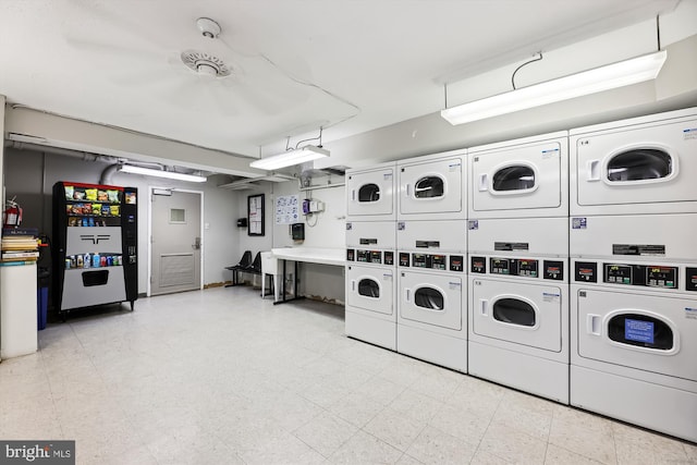 laundry area featuring stacked washer and clothes dryer and washer and clothes dryer