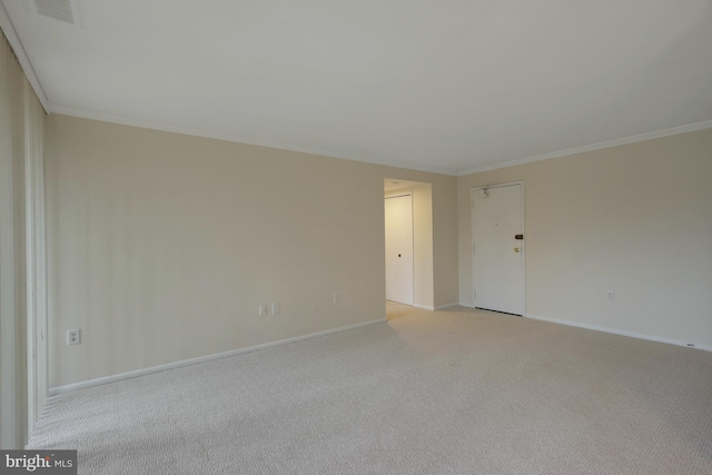 unfurnished room with ornamental molding and light carpet