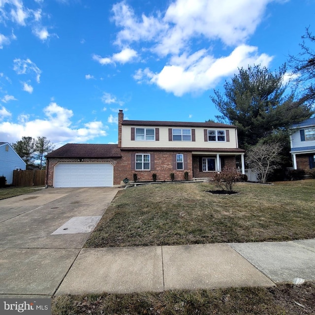 view of property featuring a garage and a front lawn