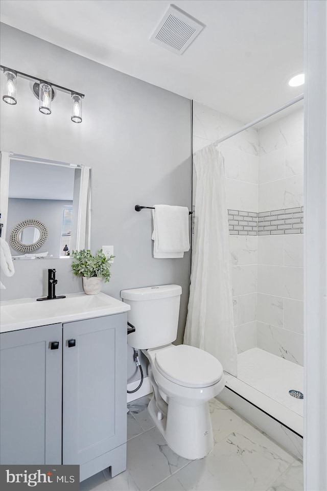 bathroom featuring toilet, vanity, and a shower with shower curtain