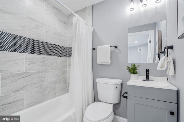 full bathroom with vanity, shower / tub combo, and toilet