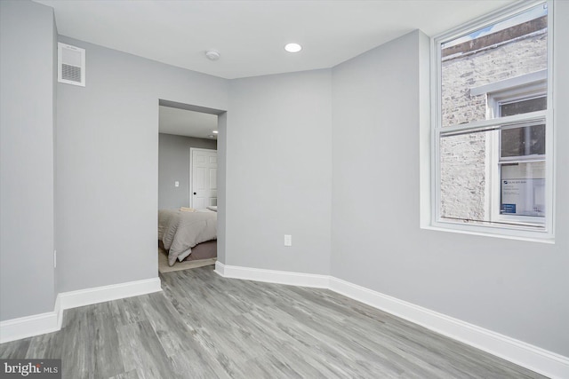 unfurnished room featuring light hardwood / wood-style floors